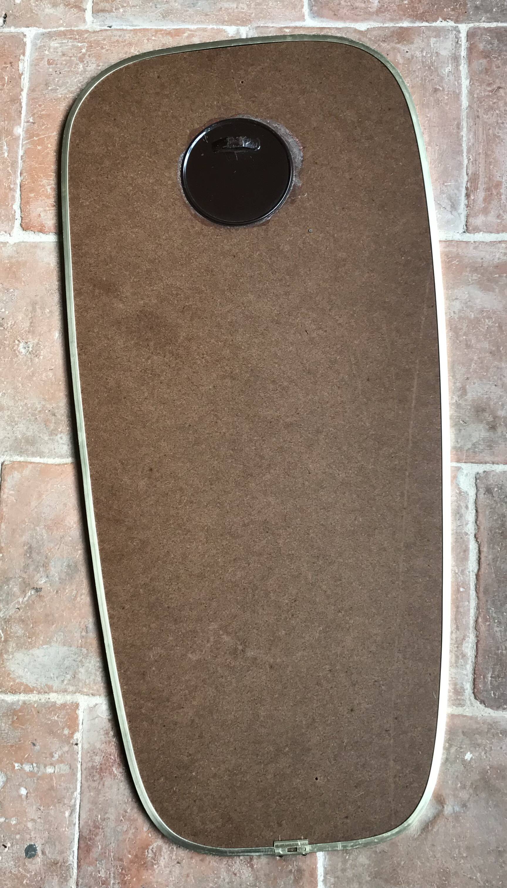 Vintage 1960 free-form mirror known as a retro mirror with a gold and black metal trim.