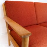 Three seater sofa of oak and red wool fabric designed by Hans J. Wegner