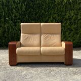 Set of vintage armchair and 2-seater sofa in beige leather and reclining wooden armrests, stressless style