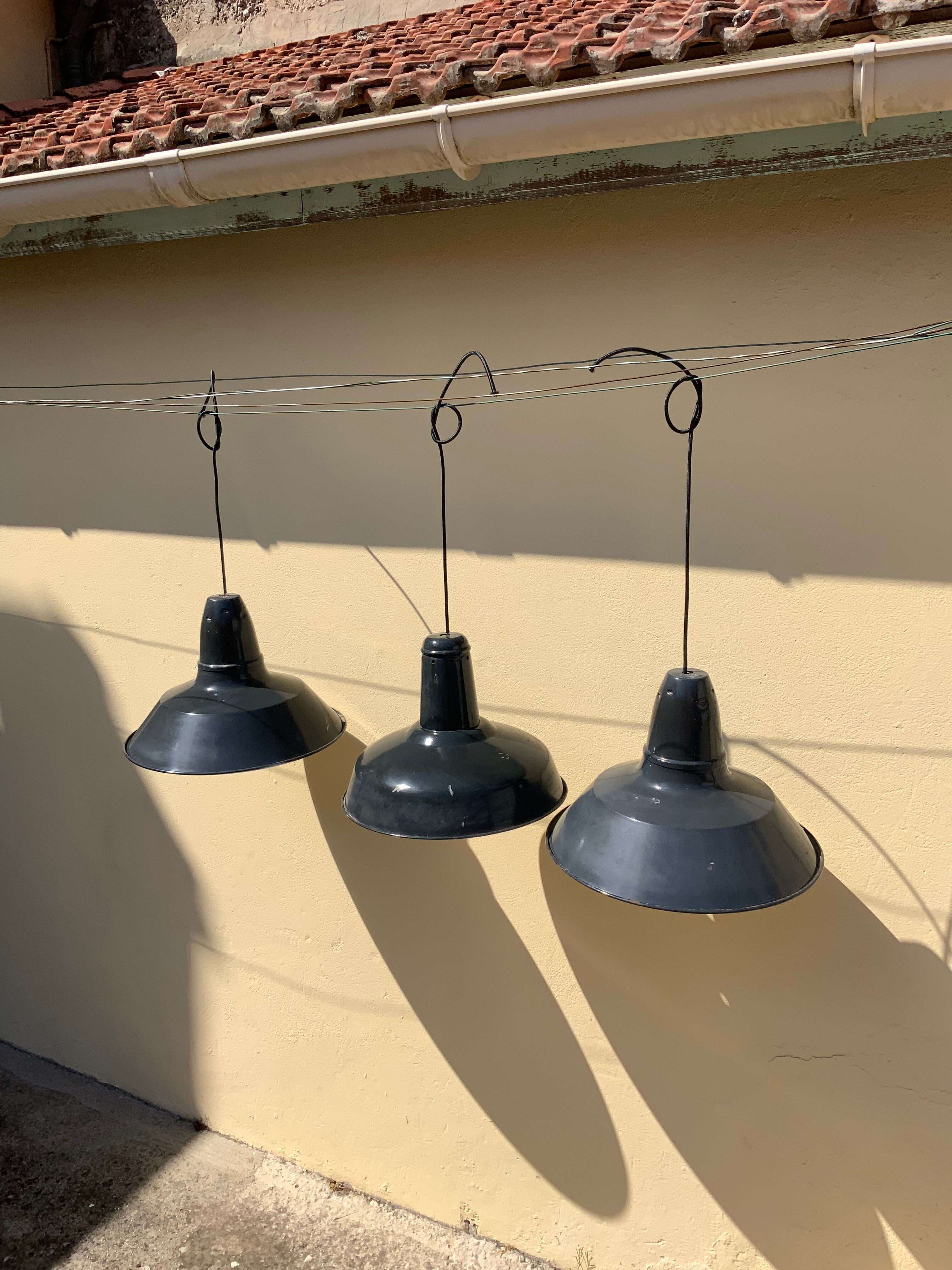 Three industrial suspensions in black and white enamelled sheet metal large format