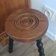 Brown and black wooden tripod stool