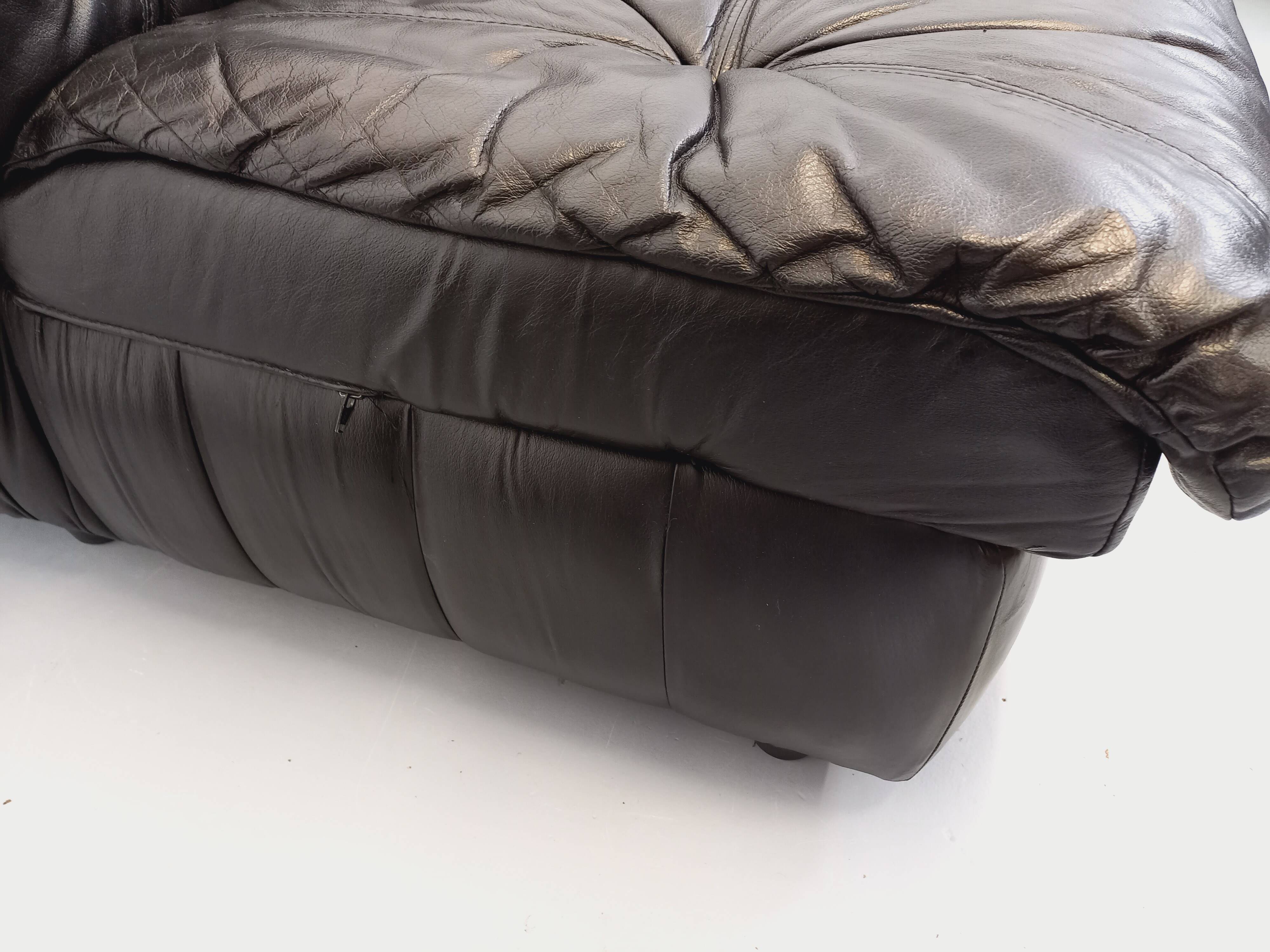 Vintage corner sofa composed of 3 modules in black leather with integrated bed.