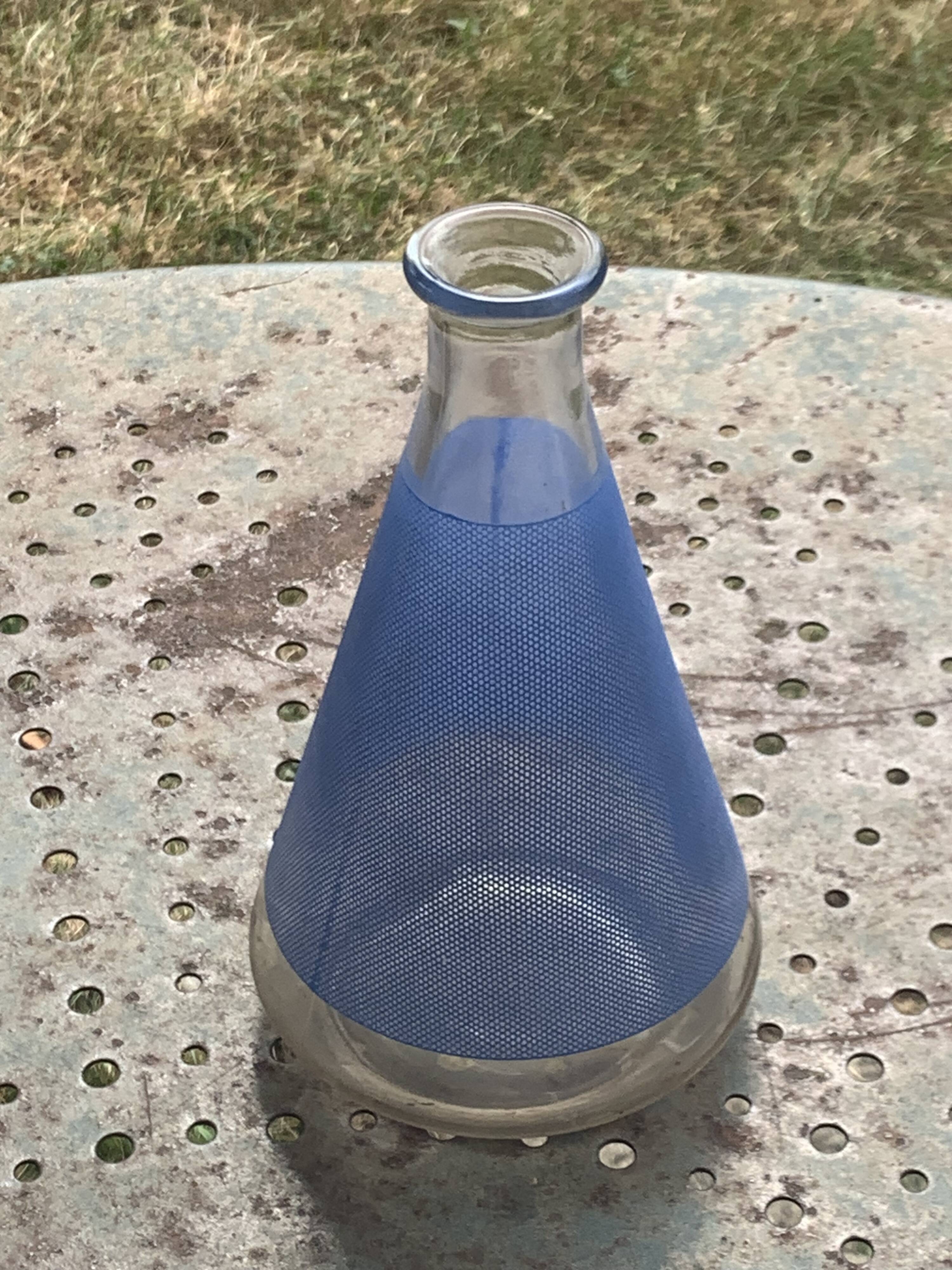 Blue glass liqueur carafe and 4 small vintage granite glasses