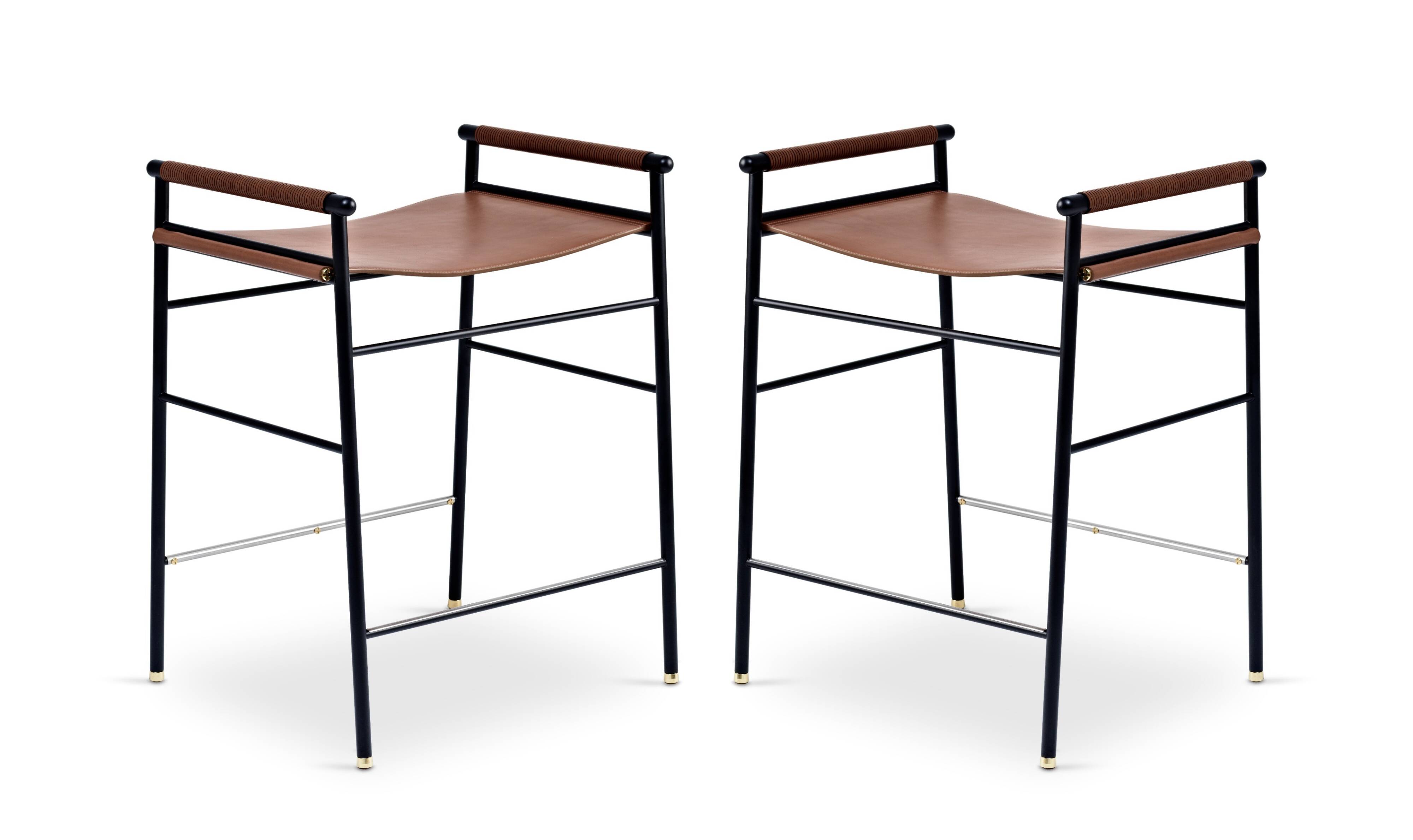 Pair of backless bar stools in brown and black metal.