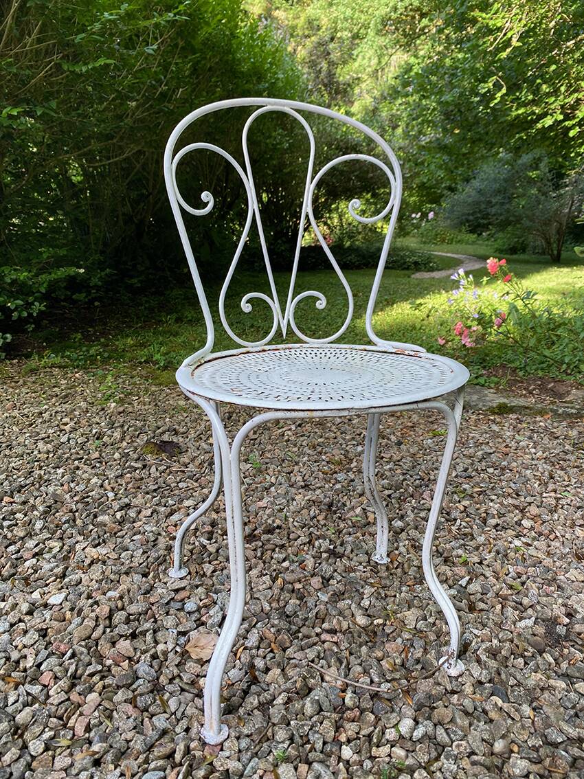 Part of a white lacquered wrought iron garden furniture set