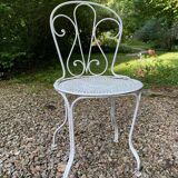Part of a white lacquered wrought iron garden furniture set