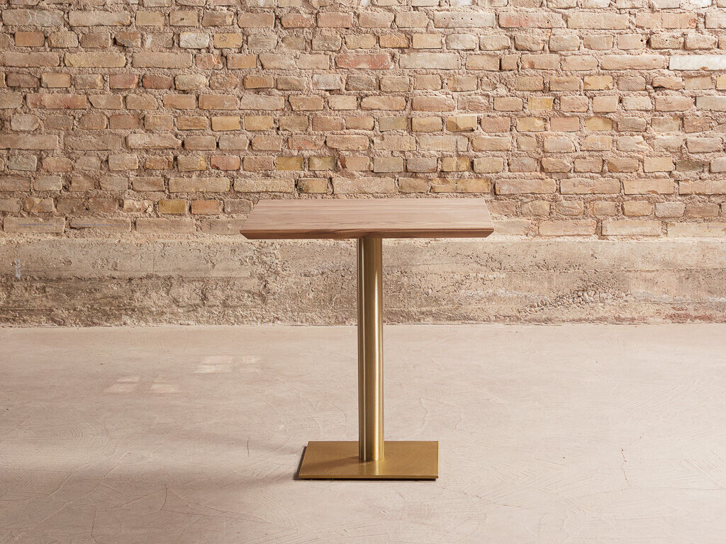 Solid walnut dining table on brass center base