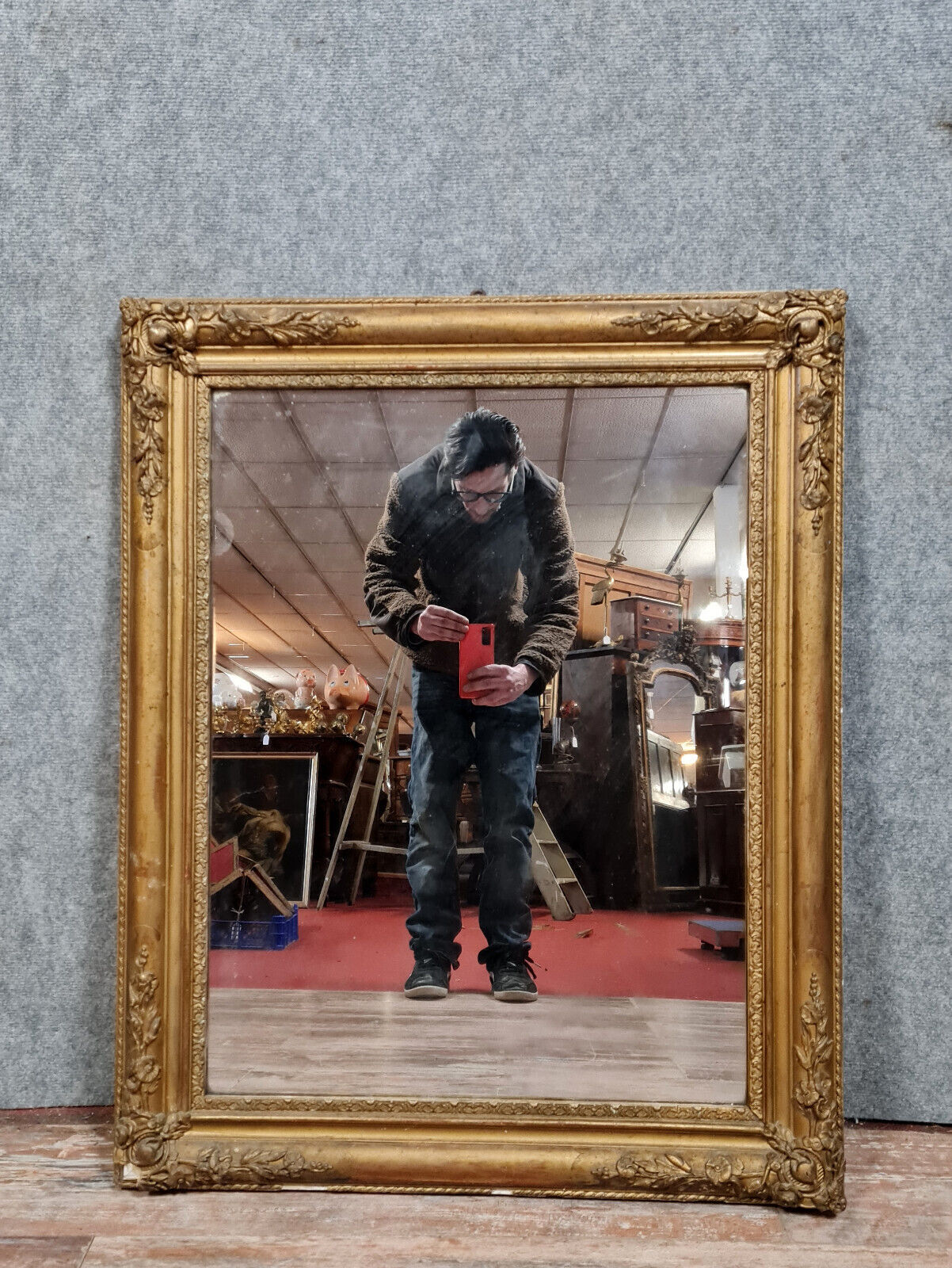Old nineteenth century mirror in gilded wood and carved around 1850