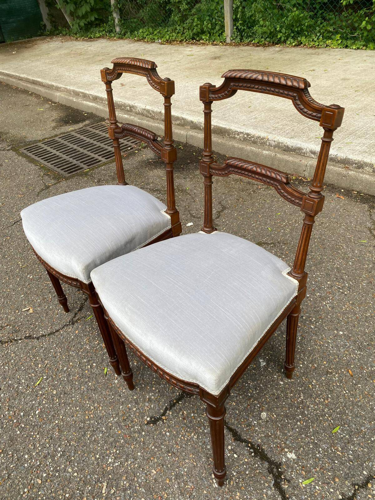 2 Louis XVI period chairs in solid wood and grey fabric.