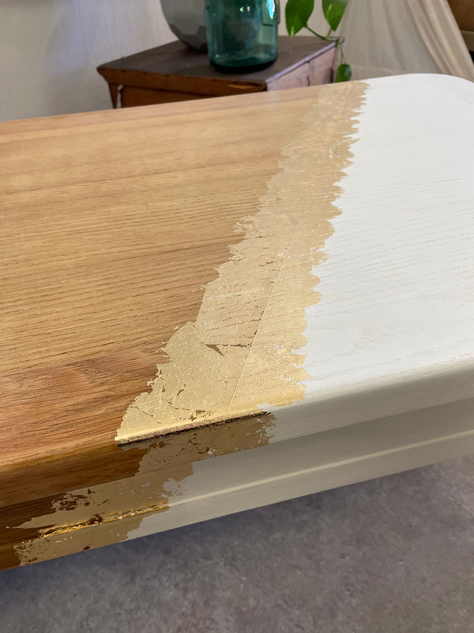 Coffee table with pin legs and gold leaf