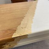 Coffee table with pin legs and gold leaf