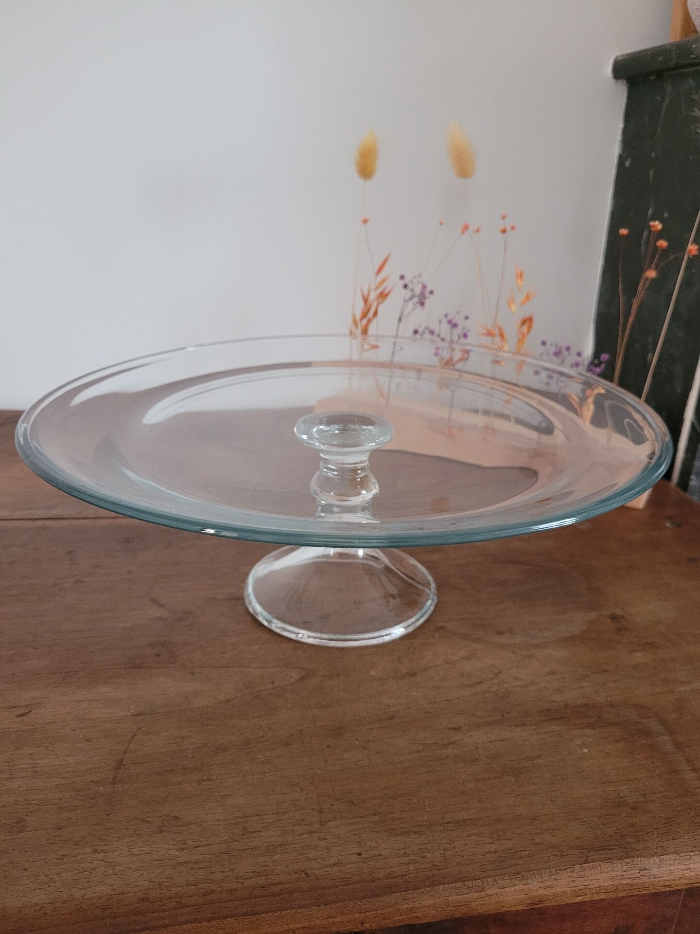 Large glass display plate mounted on a stand.