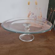 Large glass display plate mounted on a stand.