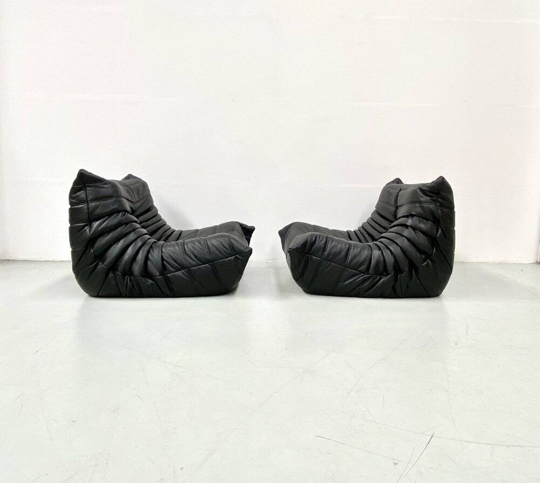Togo lounge chairs in black leather attributed to Michel Ducaroy for Ligne Roset, set of 2