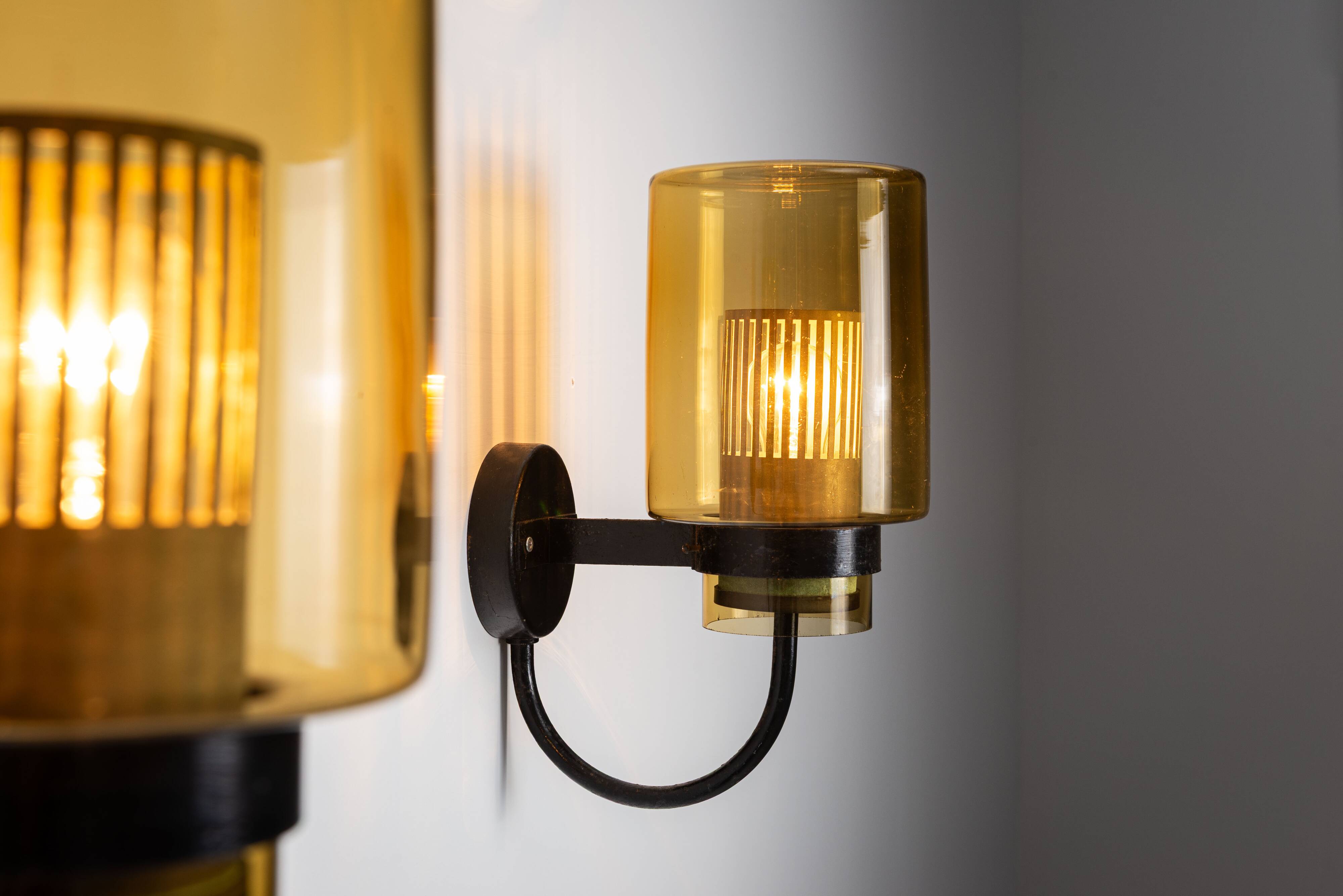 Pair of black metal wall lamps with yellow shades and inner diffuser