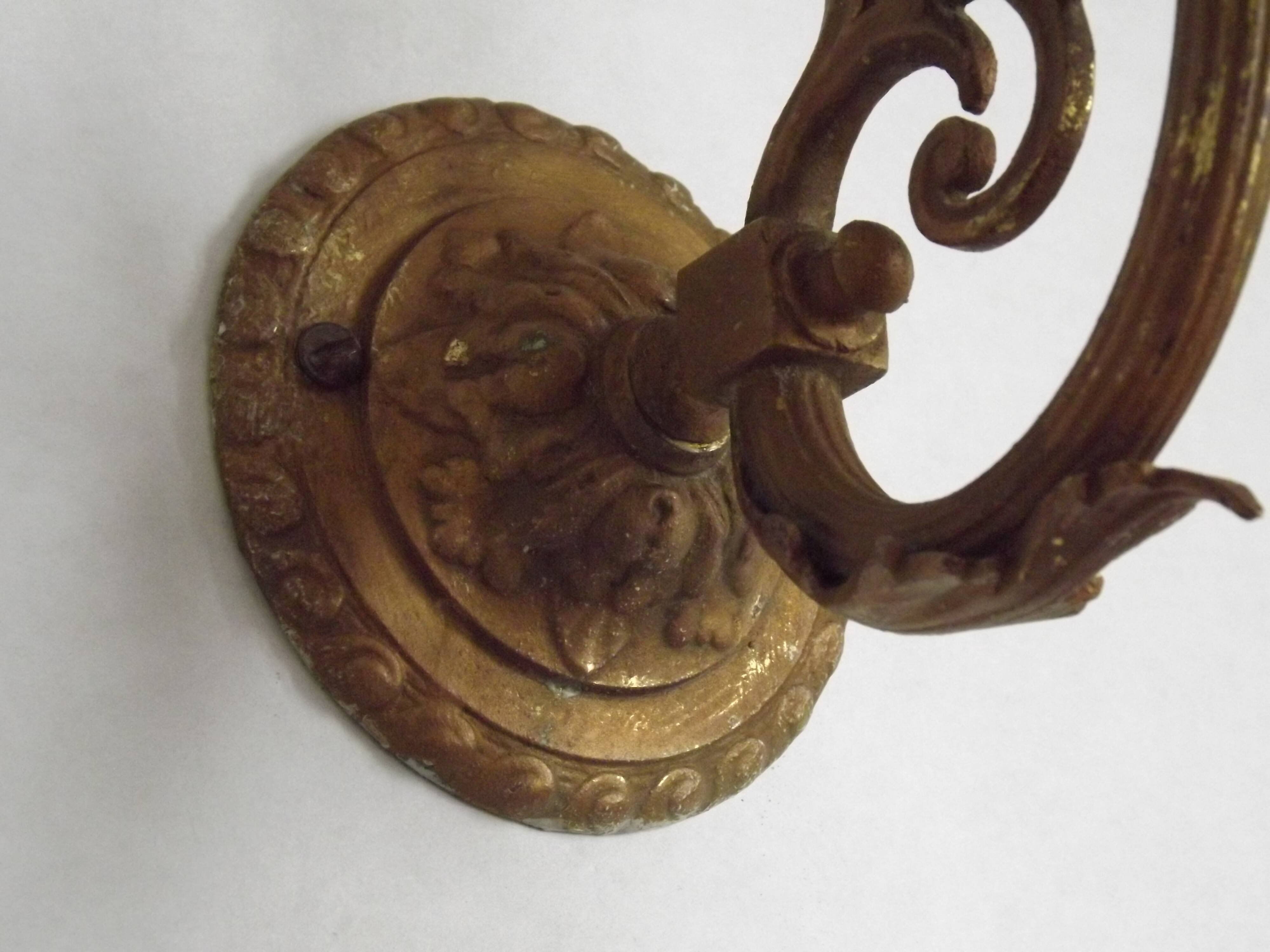 French Art Nouveau wall sconce in bronze with a white and pink glass shade.