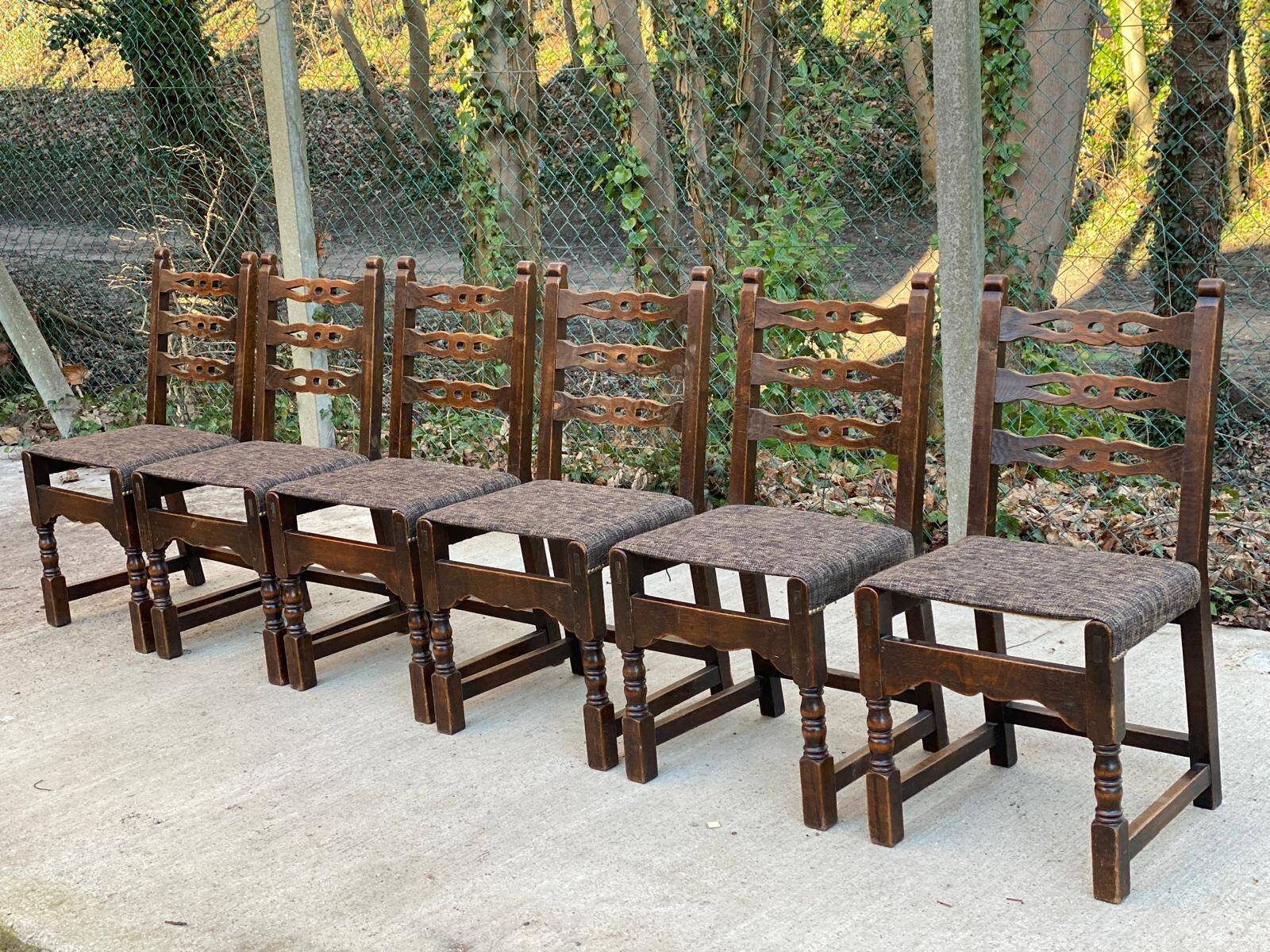 6 solid wood dining chairs with grey woven wool seats.