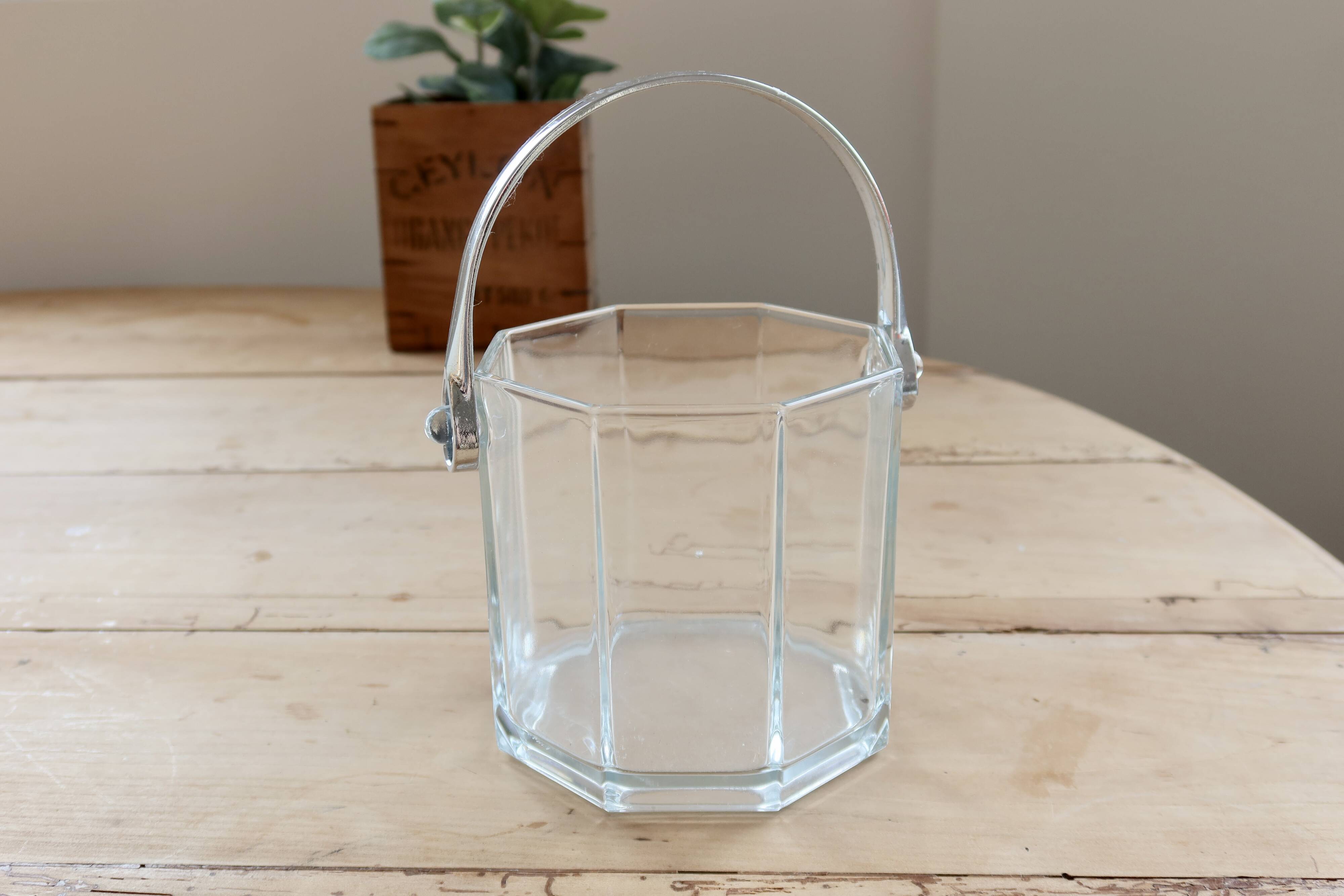 Vintage glass ice bucket with chrome handle.