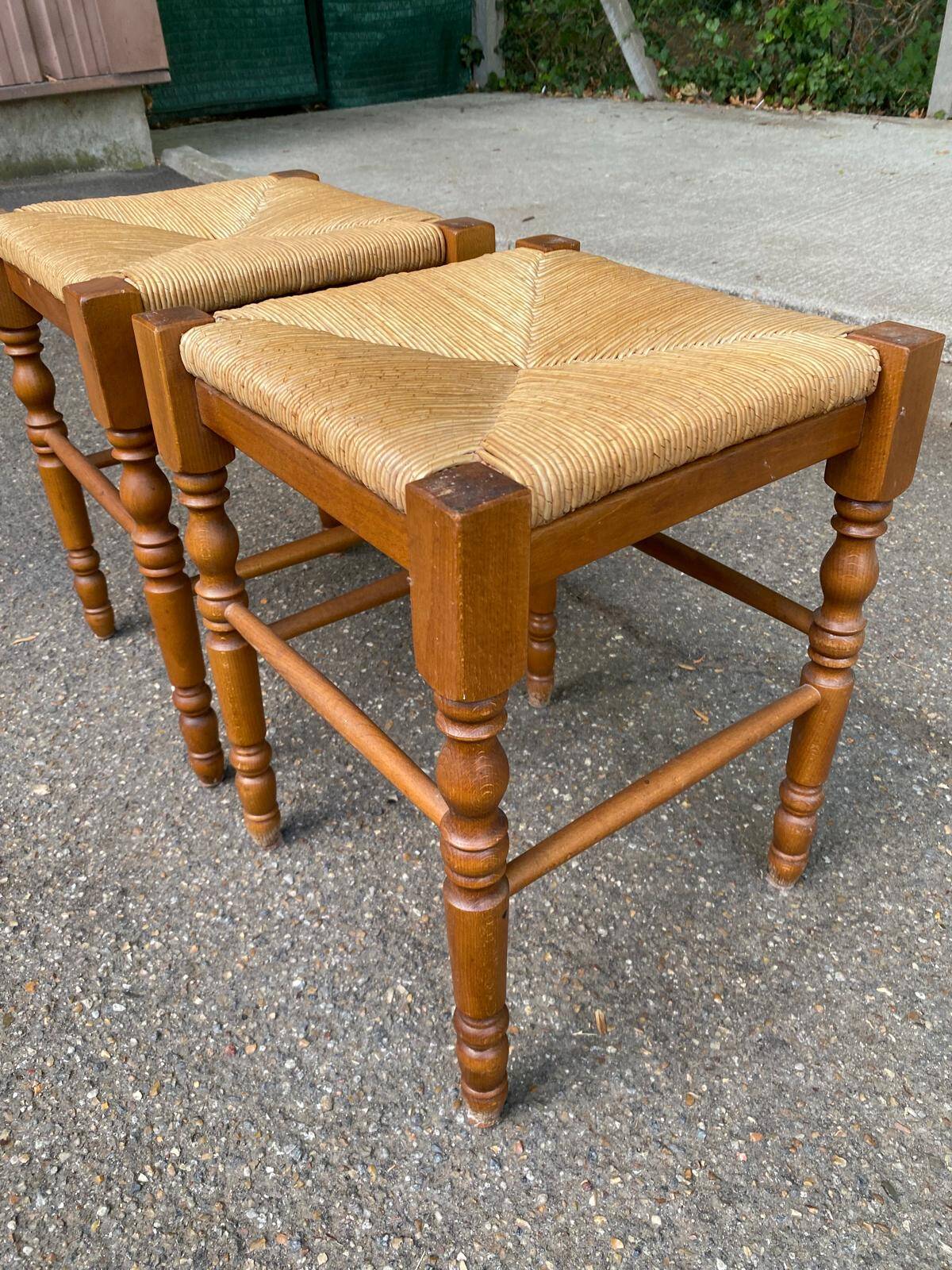 2 square stools made of carved solid wood with rush seats from the 1970s.