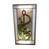 Old stained glass sign with deciduous decoration and microscope