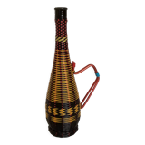 Old bottle in yellow, red and black scoubidou