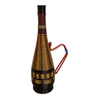 Old bottle in yellow red and black scoubidou