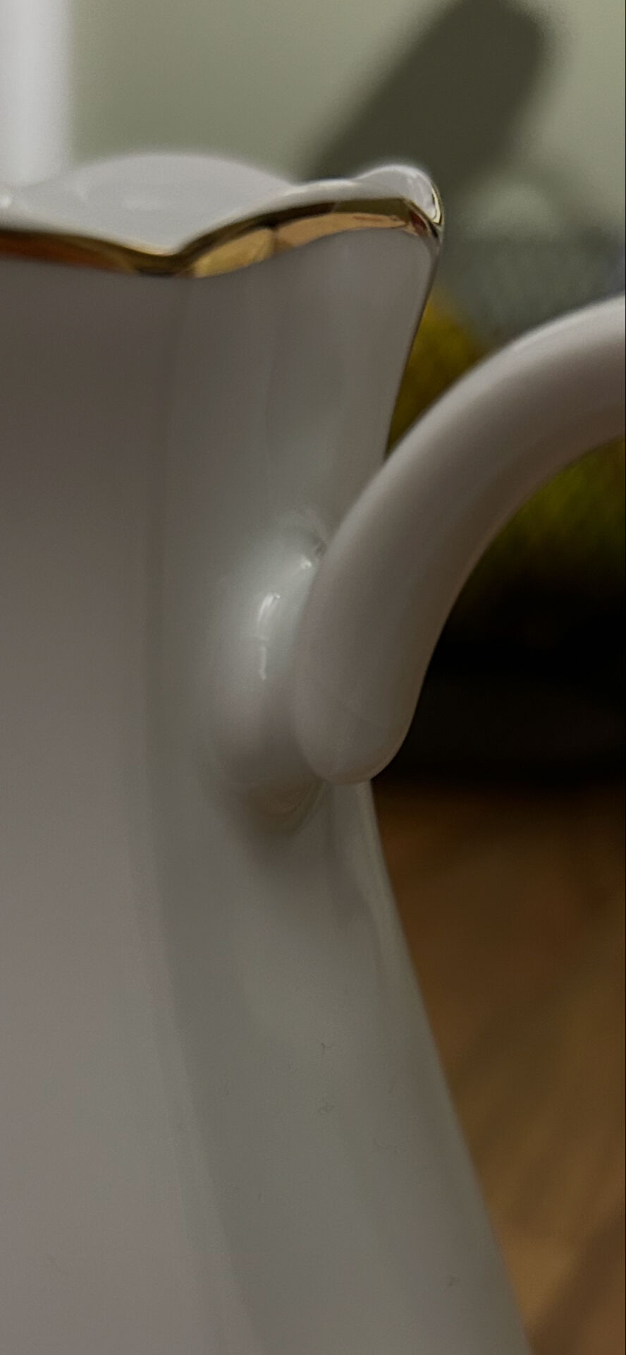 Vintage coffee pot in white porcelain with a gold trim.