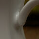 Vintage coffee pot in white porcelain with a gold trim.