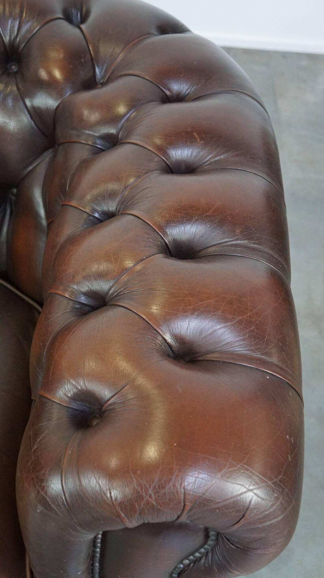 Beautiful and spacious dark brown mottled English cow leather Chesterfield armchair