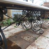 Marble table with wrought iron legs.