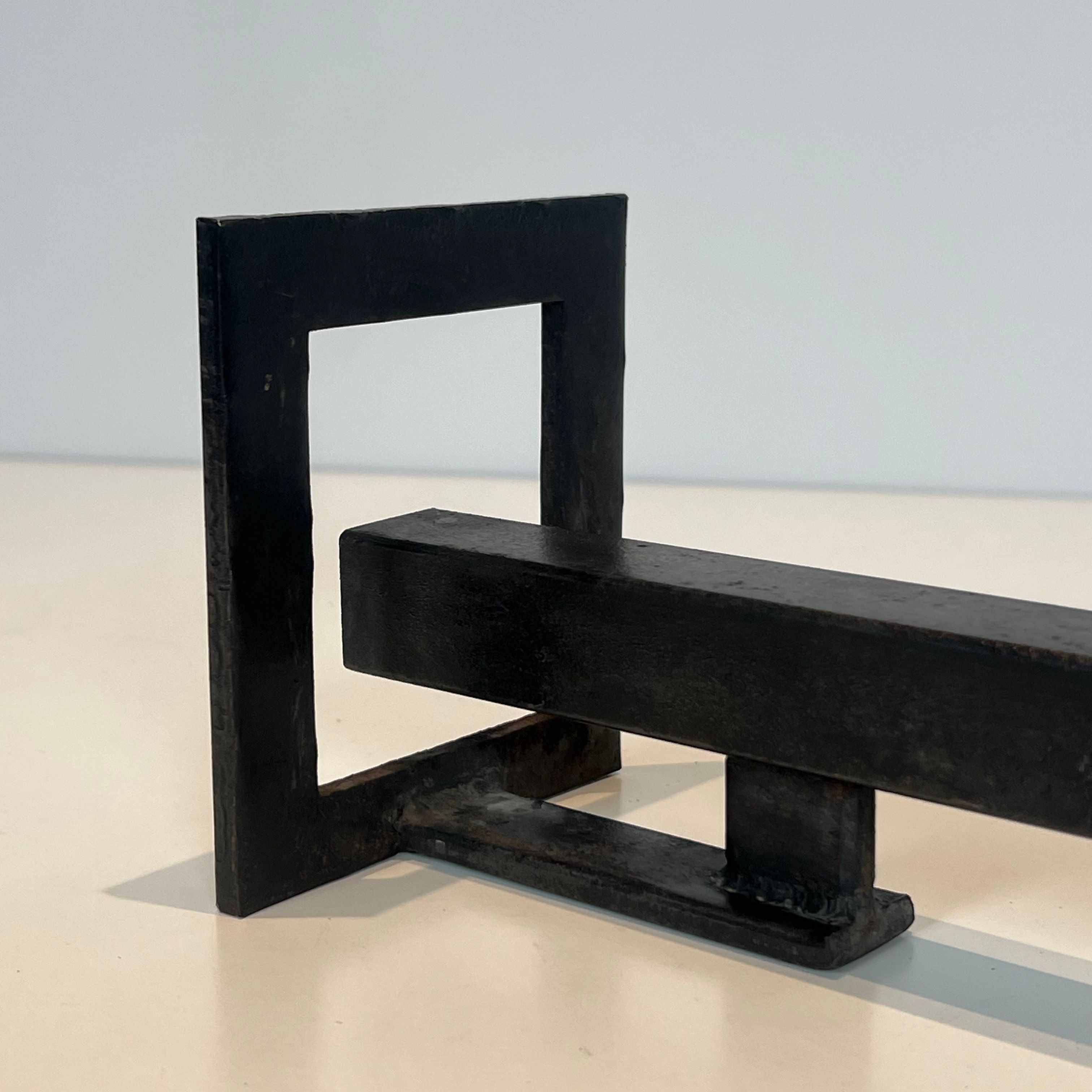 Pair of modernist andirons in steel and wrought iron