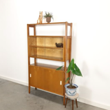 Vintage wooden showcase with sliding doors and white handles