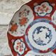 Antique Imari deep plate with red and blue floral decoration, 21.5cm.