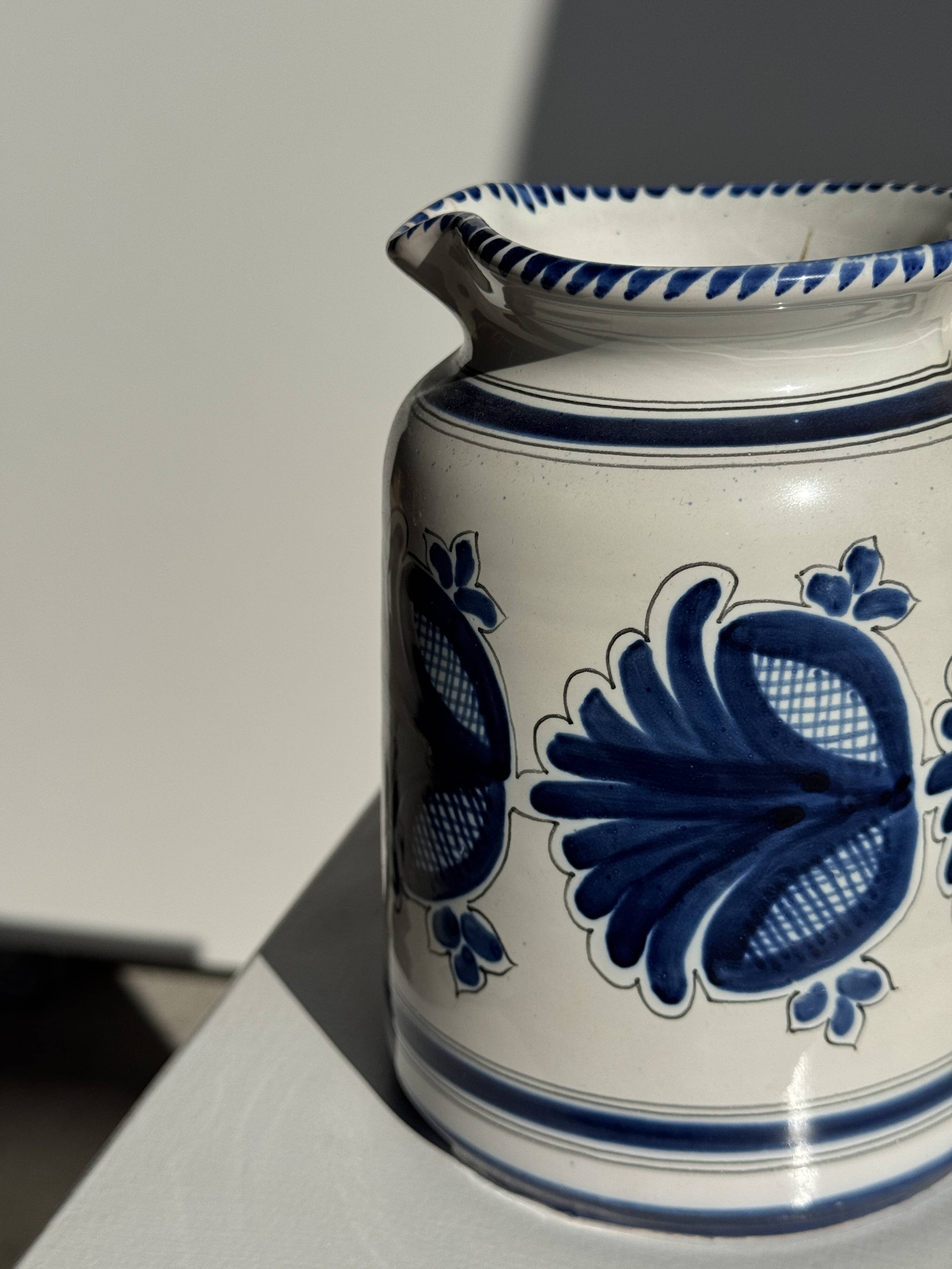 Artisan blue floral decorative carafe, height 17 cm, diameter 24.5 cm.