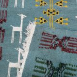 Blue carpet with gazelle patterns woven by hand