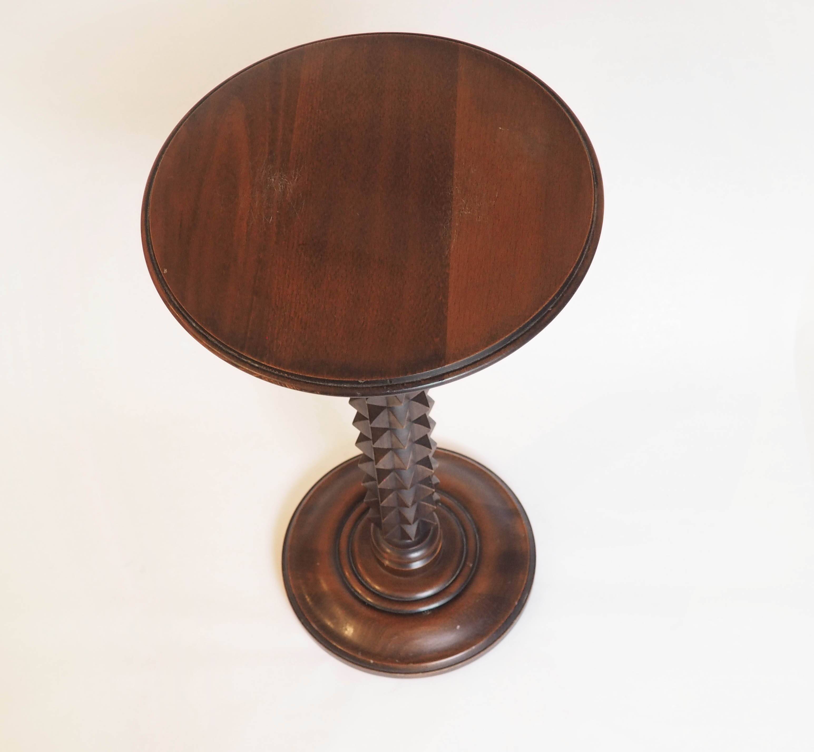 Wooden pedestal table with spiked columns