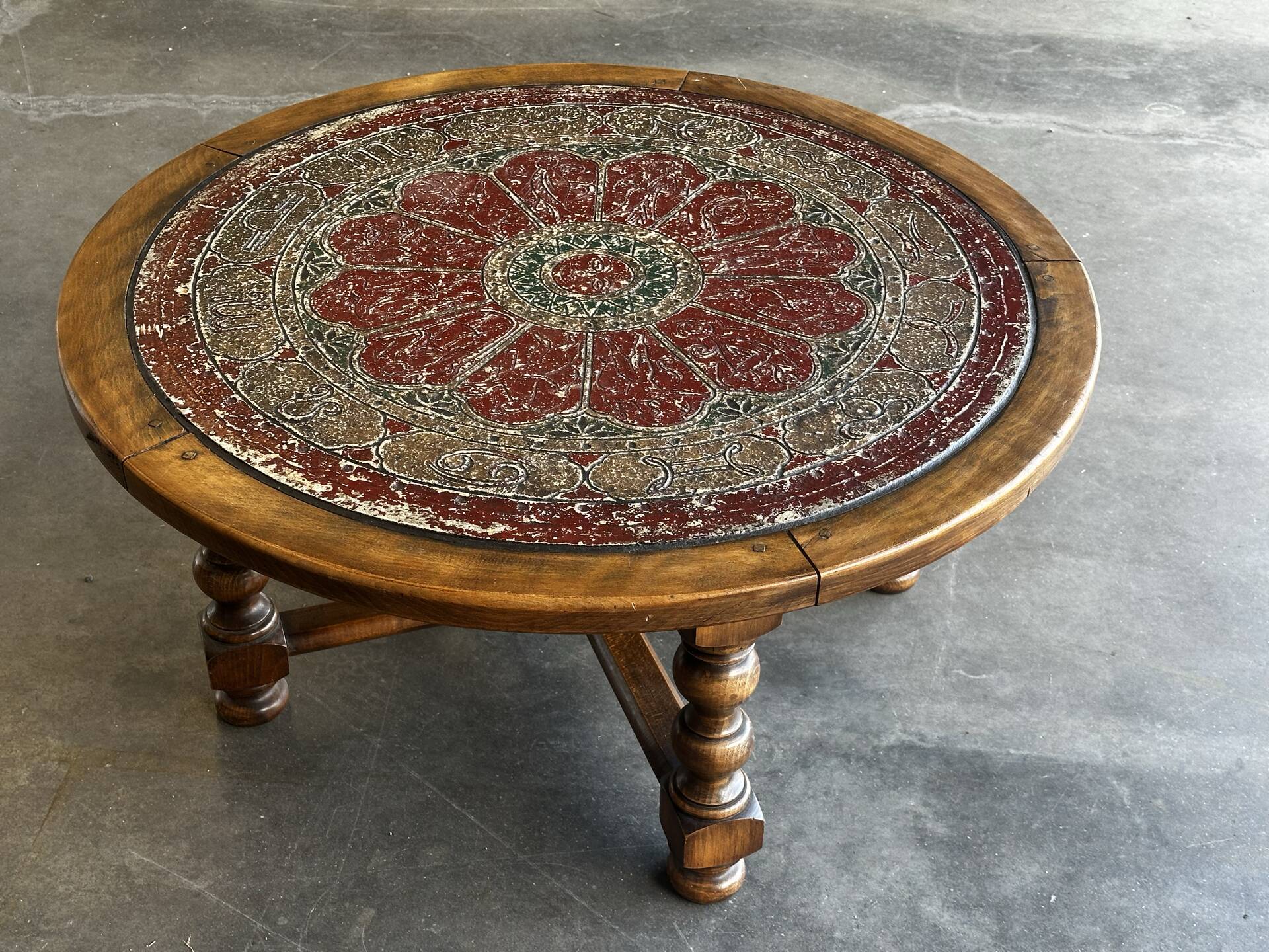 Vintage coffee table in turned wood and leather with astrological decoration.