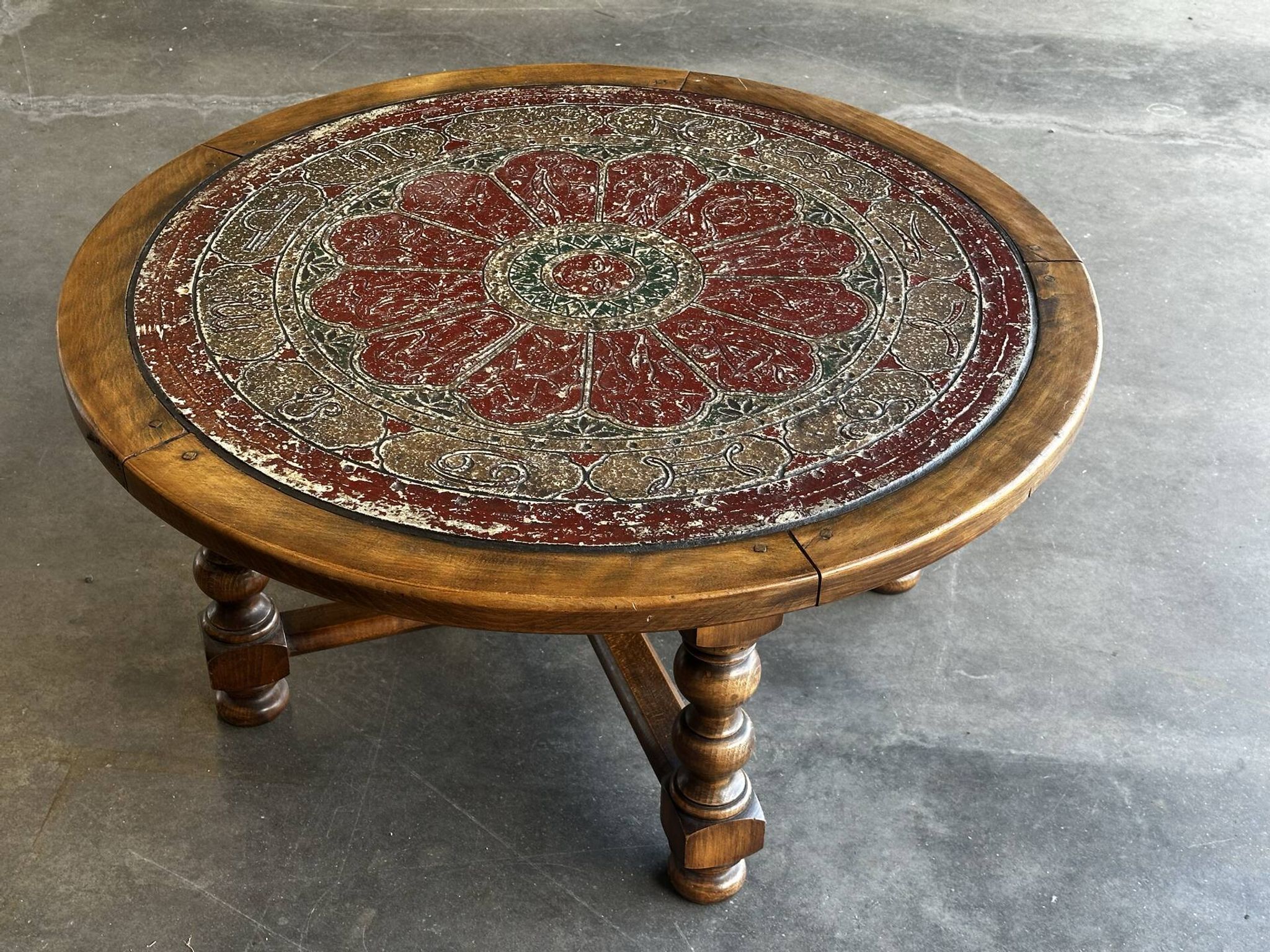 Vintage wooden turned coffee table with leather and astrological decoration.