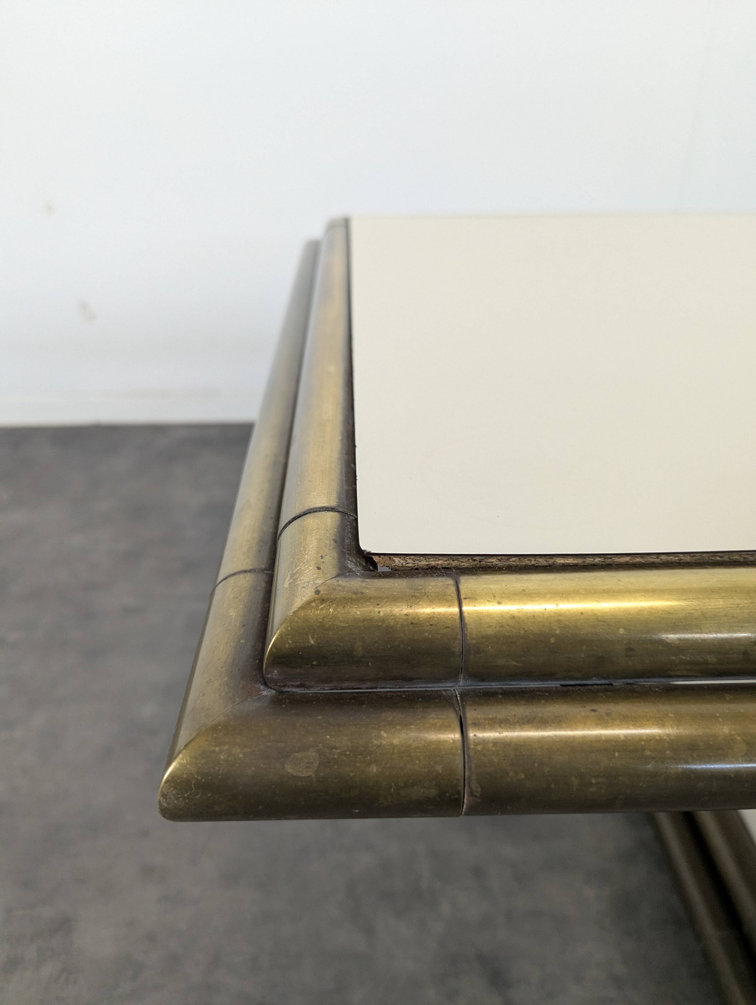 1980s coffee table made of brass tubes and laminate.