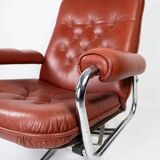 Armchair upholstered with red leather and frame of metal, of danish design from the 1960s