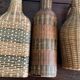 Set of three vintage rattan bottles