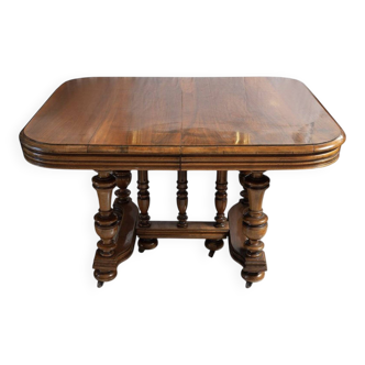 Extendable wheeled table henri ii, second half of the 19th century, solid walnut.