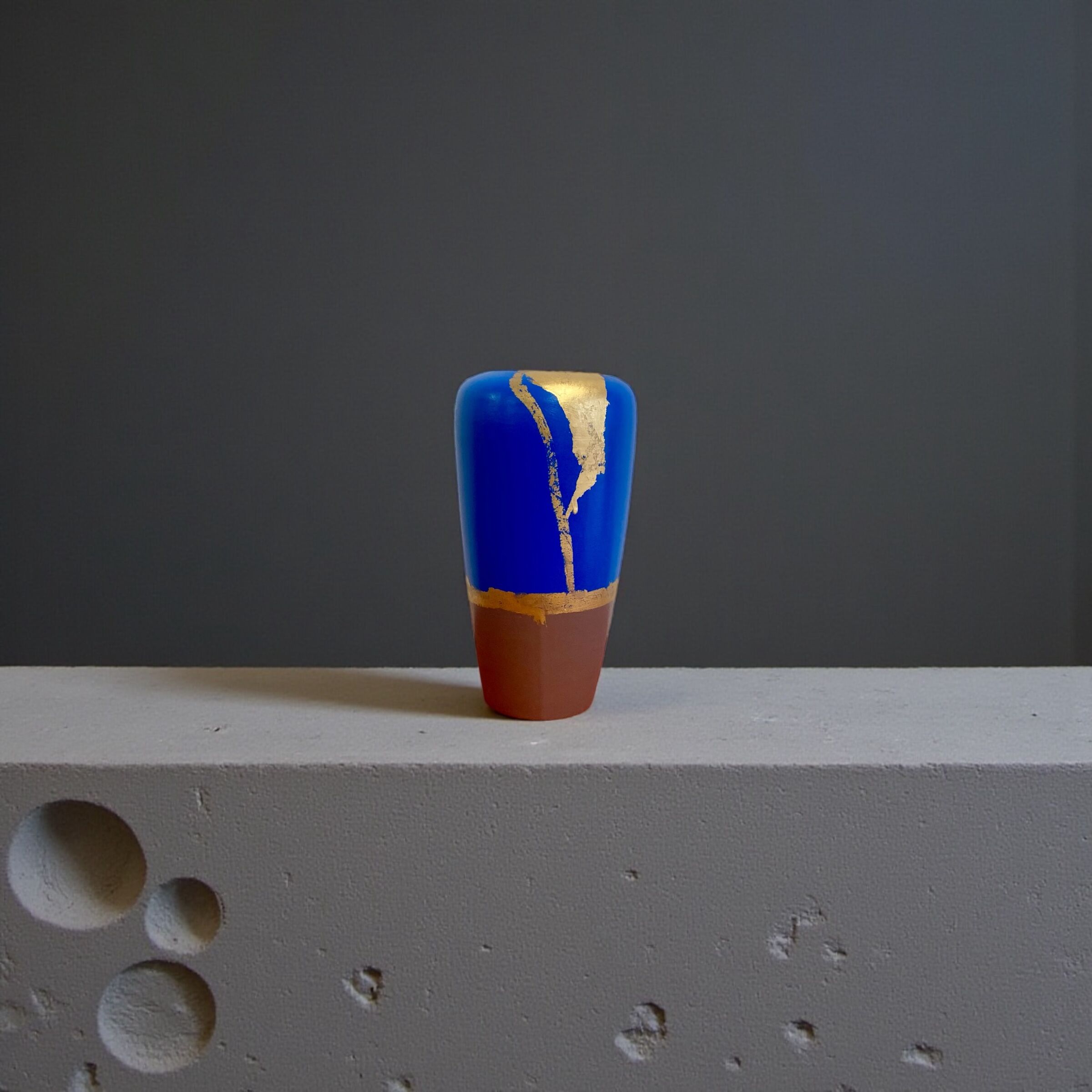 Electric blue and frosted brown decorative vase with gold leaf.