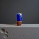Electric blue and frosted brown decorative vase with gold leaf.