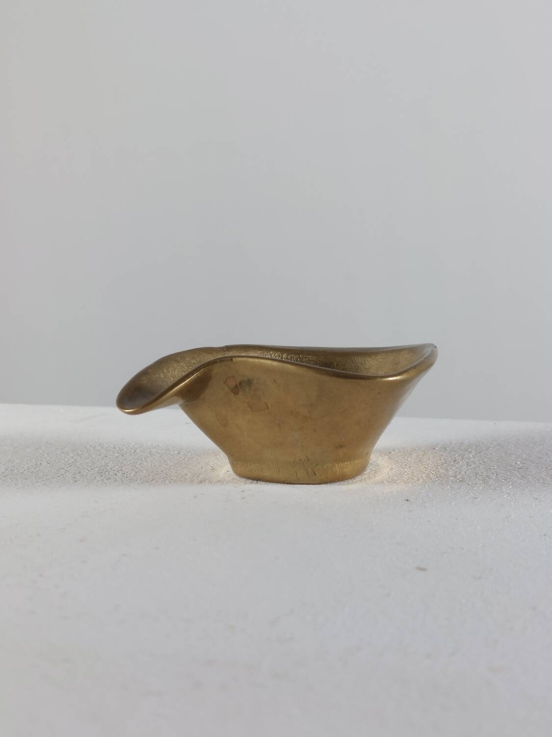 Vintage brass ashtray with an organic design from the 1950s.