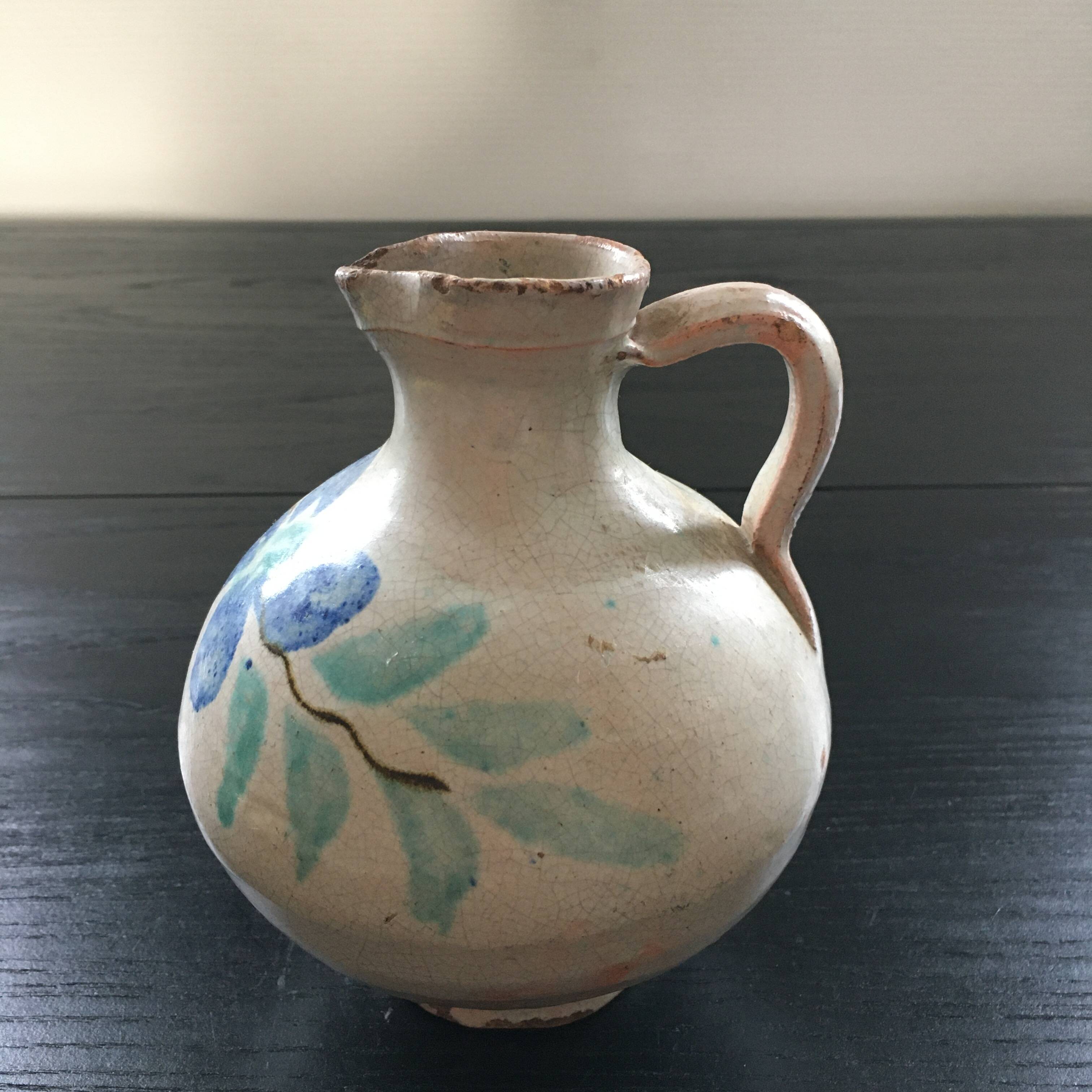 Antique pitcher with floral decoration