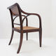 Mid-century curved wooden chairs with cane seats and backs.