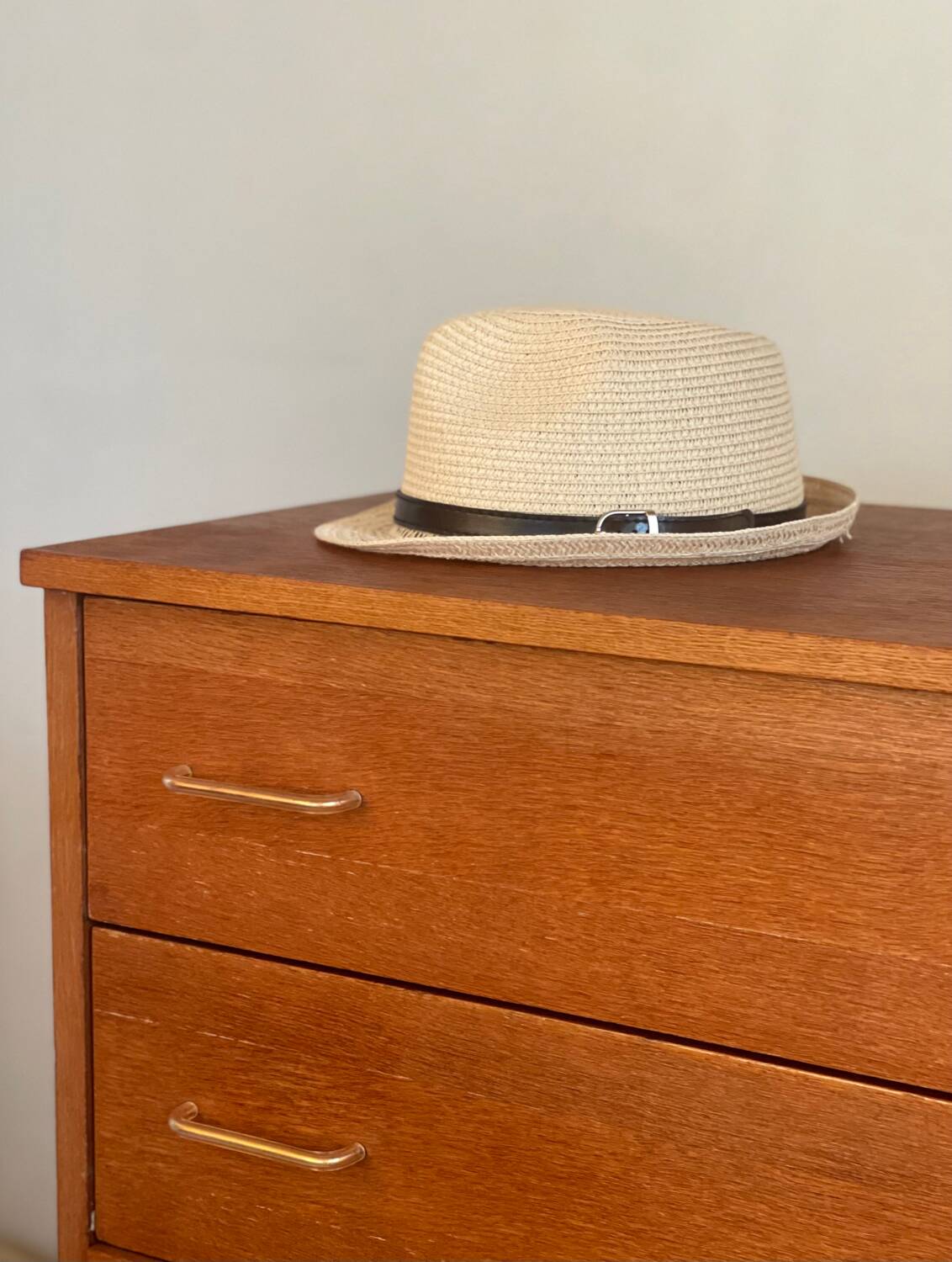 Vintage 1960s chest of drawers with covered handles.
