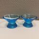 Two small candle holders in blue glass from the well-known Finnish company Ittala.