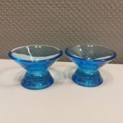 Two small candle holders in blue glass from the well-known Finnish company Ittala.
